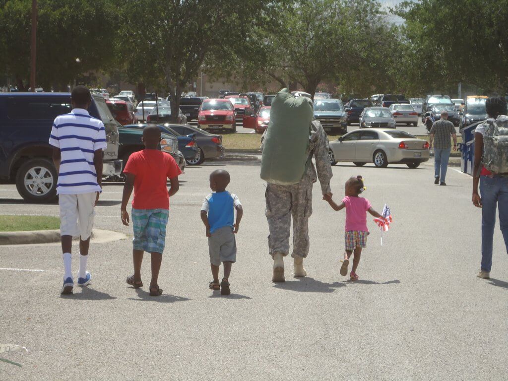 Army Chaplain (Maj.) Patrick Kihiu with his family arriving home from a deployment July 2012