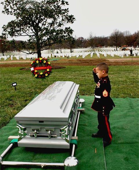 Javier Ortiz Rivera's son salutes his father's casket at his funeral in 2010.