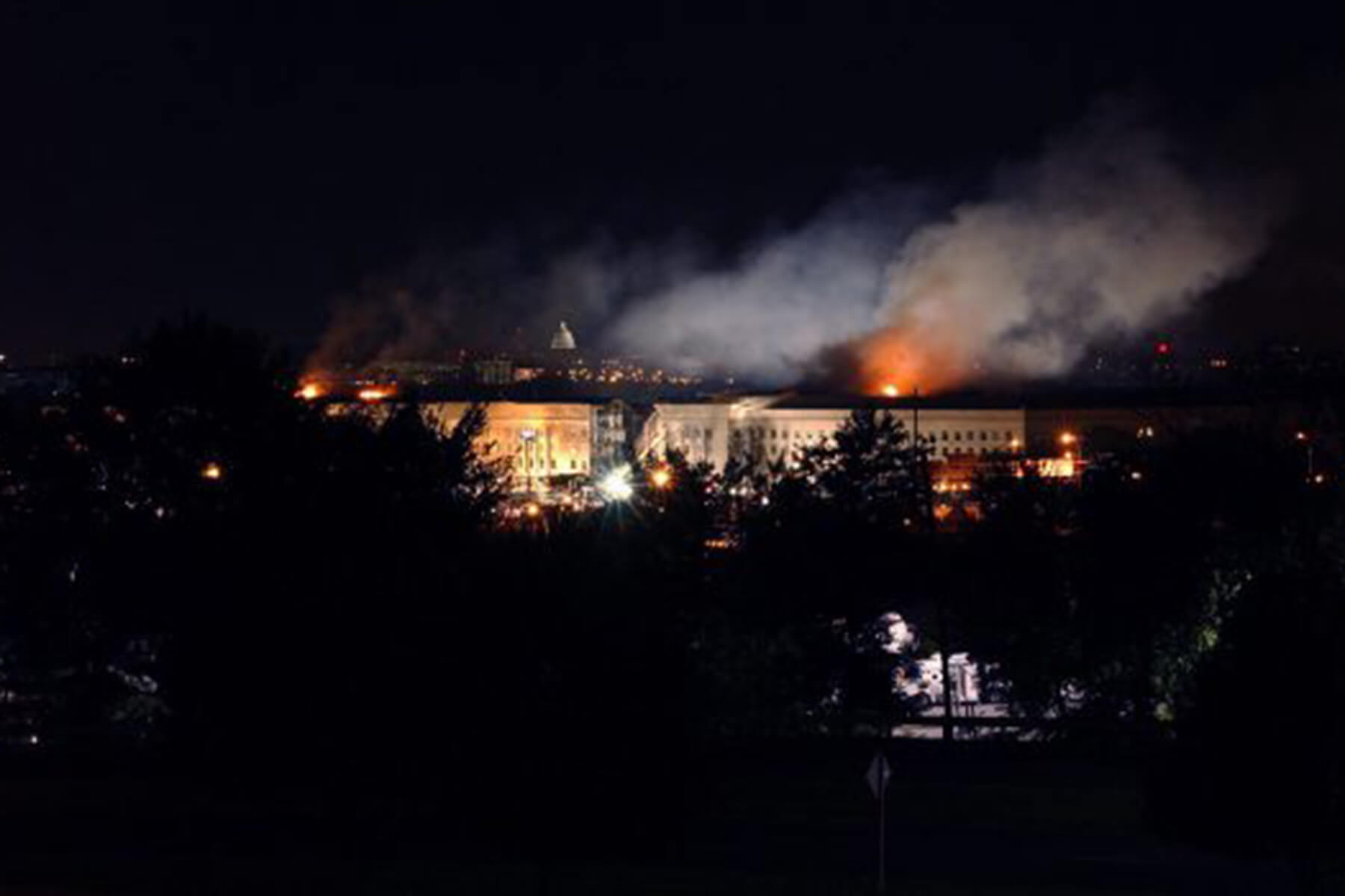  Smoke and flame appear in the Washington skyline in the aftermath of the terrorist attack on the Pentagon, Sept. 11, 2001.Navy Petty Officer 2nd Class Robert Houlihan