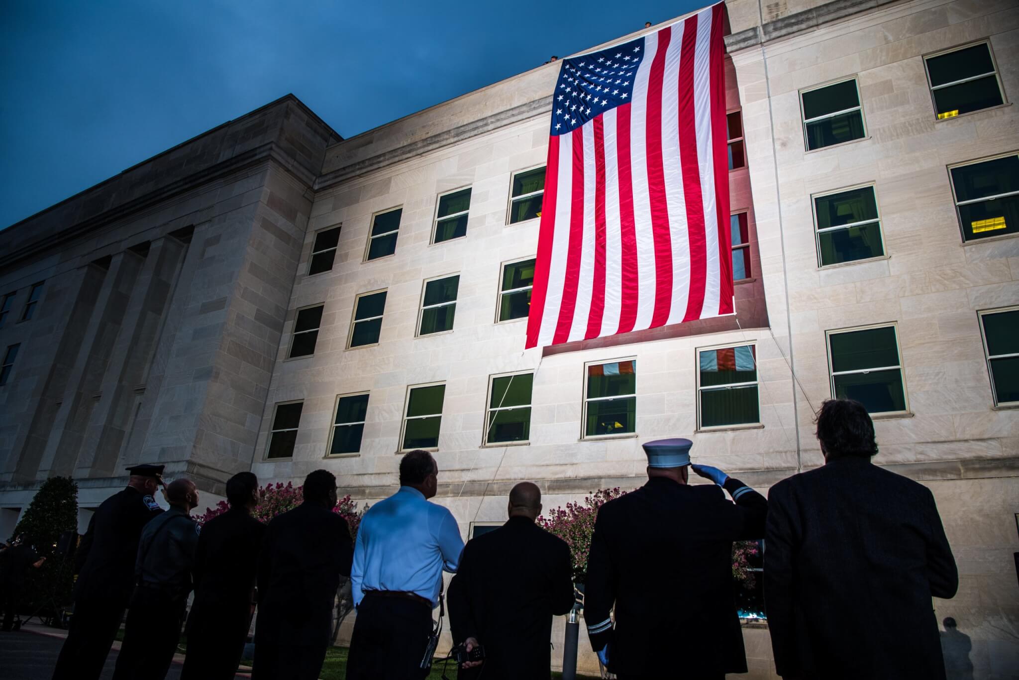 A Pentagon crew unfurls an American flag at dawn at the Pentagon, on the 18th anniversary of the 9/11 attacks, Washington, D.C., Sept. 11, 2019. (DoD photo by U.S. Army Staff Sgt. Nicole Mejia)