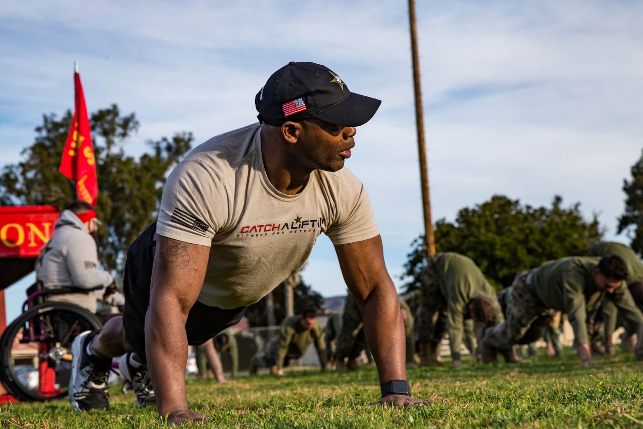 Ret. U.S. Marine Corps Master Gunnery Sgt. Carnell Martin, a member of Catch a Lift (CAL), stretches with Marines with Sierra Battery, 5th Battalion, 11th Marine Regiment, 1st Marine Division during a physical training event on Marine Corps Base Camp Pendleton, California, Jan. 24, 2020. CAL is a non-profit organization that provides combat wounded veterans with personalized fitness, nutrition and wellness grants, enabling them to heal through physical fitness and mental wellbeing. The veterans with CAL curated eight different adaptive workout stations that challenged the Marines to use different muscles for common exercises. (U.S. Marine Corps photo by Cpl. Alexa M. Hernandez)