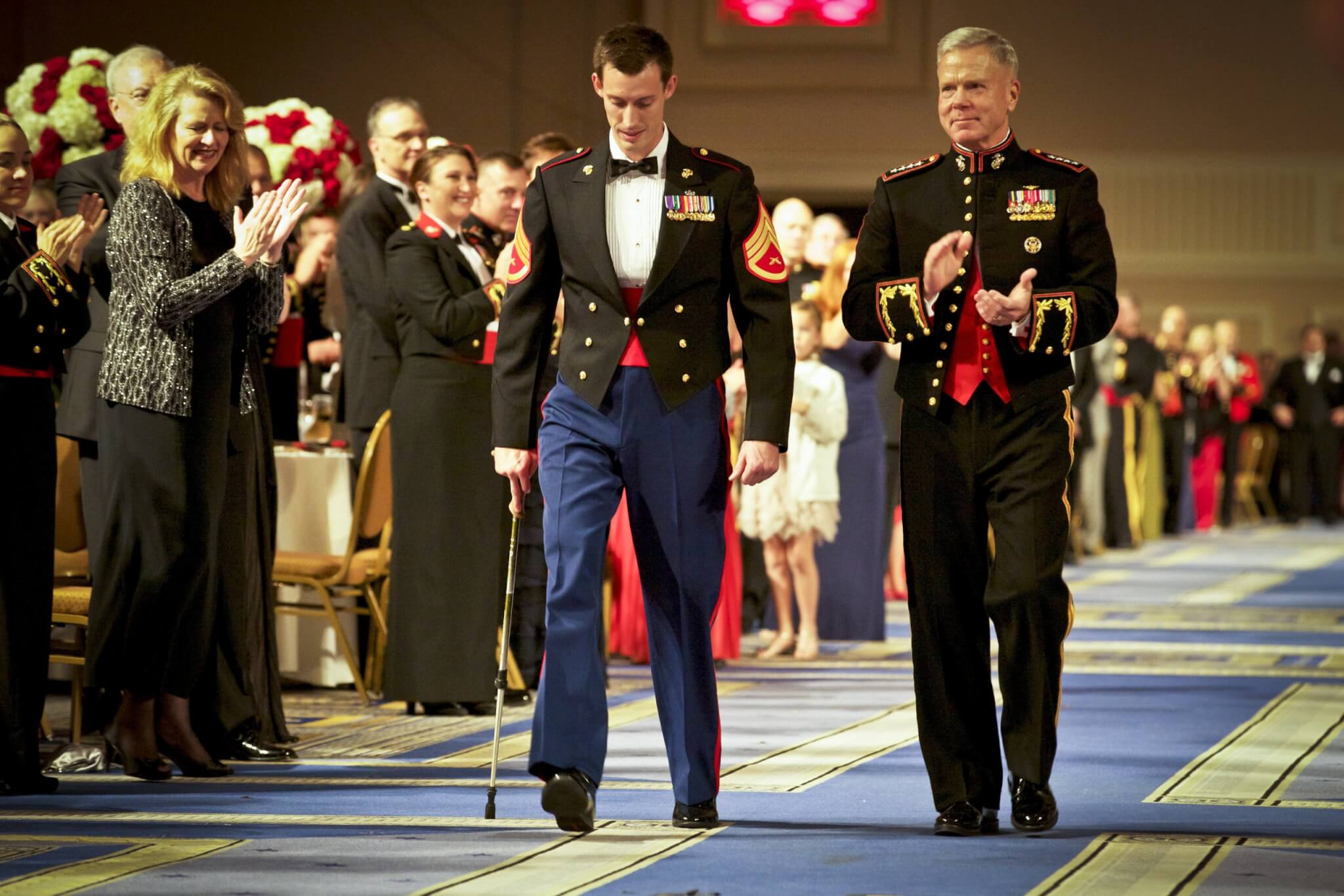 Then-Commandant of the Marine Corps Gen. James F. Amos (right), receives honors alongside Staff Sgt. Johnny Jones at the Headquarters Marine Corps Birthday Ball. Jones was on hand to represent all Wounded Warriors during the event in celebration of the 237th Marine Corps birthday. Photo by Sgt. Mallory S. VanderSchans.