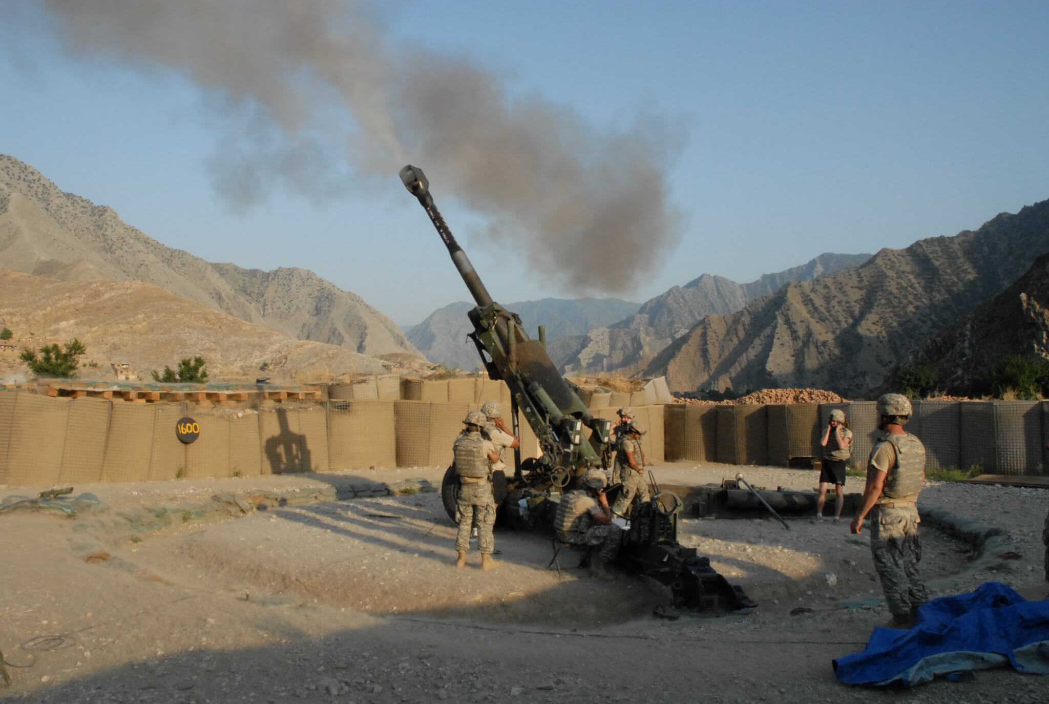  A crew from Battery B, 4th Battalion, 319th Airborne Field Artillery Regiment, fire a 155 mm howitzer in support of infantry operations in a nearby valley at Forward Operating Base Blessing in eastern Afghanistan during the war on terrorism.. Photo by Mark St. Clair / ©2007 Stars and Stripes, All Rights Reserved