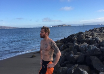 Paralympian and U.S. Naval Academy graduate Brad Snyder stands on the beach after an open-water training session. Snyder has stepped into an informal leadership training role at the Naval Academy. Photo credit: Courtesy photo Brad Snyder