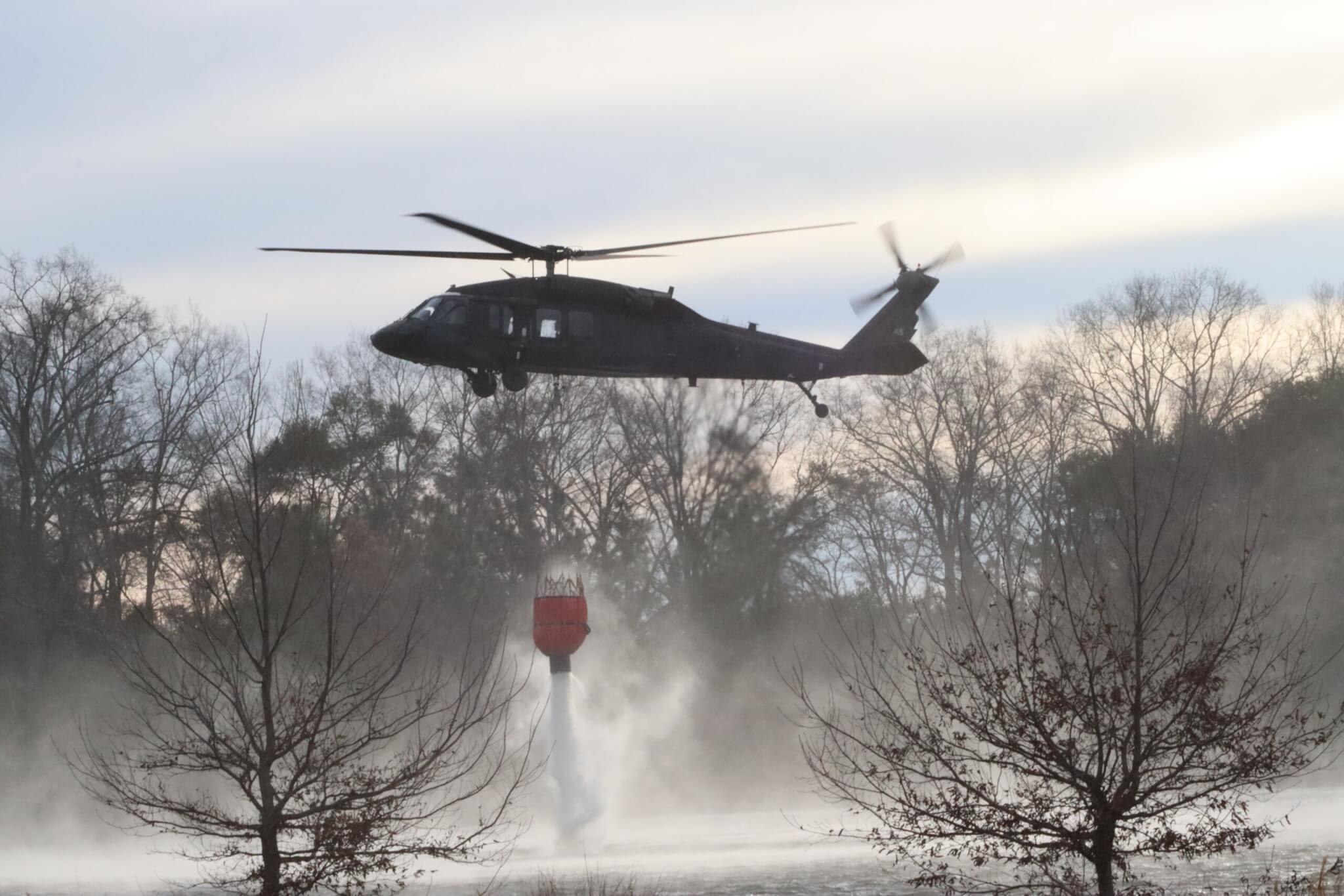 Soldiers with Company A, 111th General Support Aviation Battalion, 59 Aviation Troop Command, South Carolina National Guard prepare two Blackhawk Helicopters to assist the South Carolina Forestry Commission and the South Carolina Department of Natural Resources with wildfire containment in Horry County, South Carolina, March 2, 2025. The Blackhawk water buckets for this mission can carry approximately 600 gallons of water. (U.S. Army Photo by Sgt. Elizabeth A. Schneider, South Carolina National Guard)