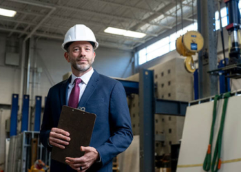 A man in a suit wearing. a hard had represents the Lean Six Sigma methodology