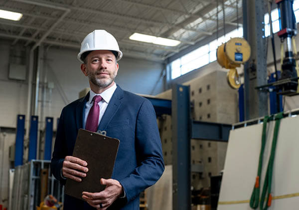 A man in a suit wearing. a hard had represents the Lean Six Sigma methodology
