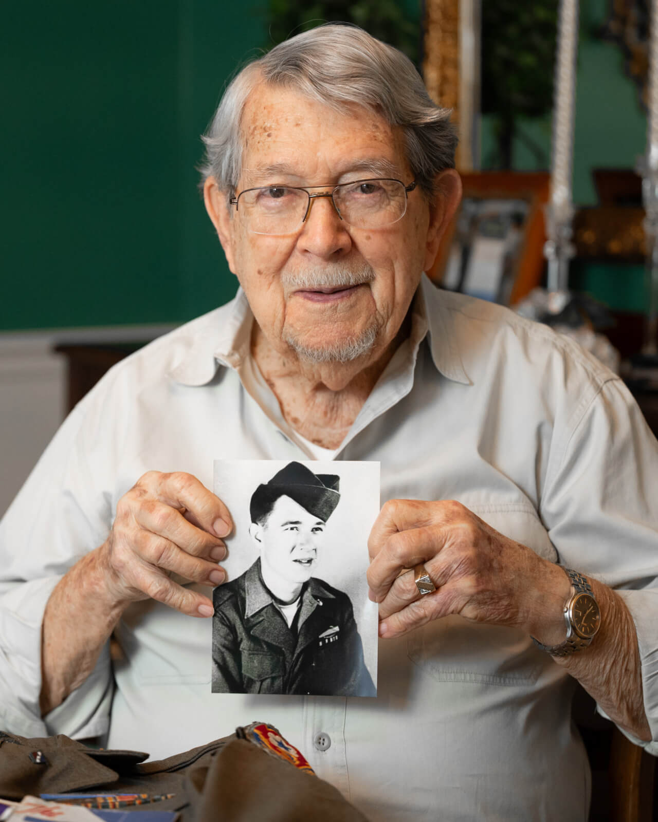 World War II veteran Vernon Brantley holds his military service photo.