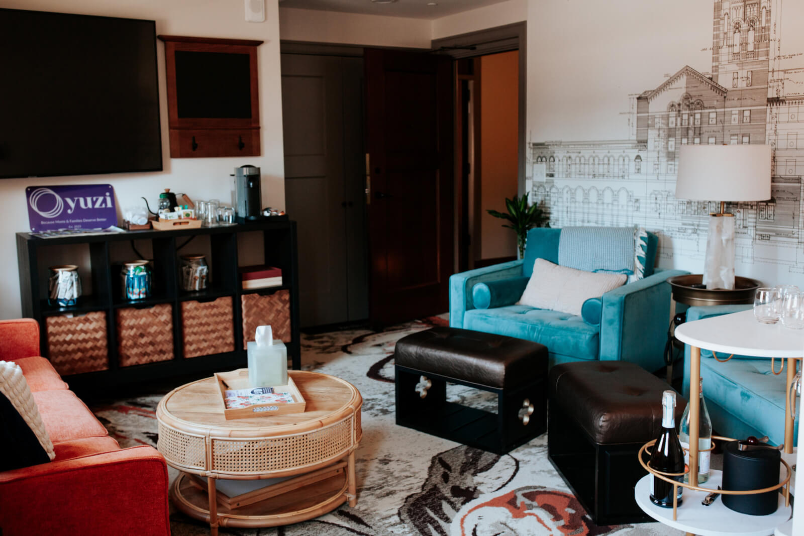 Parents' lounge from Yuzi Care postnatal retreat, with blue glider rockers, a pink couch, and a coffee and tea area for parents to relax.