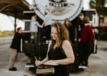 Veteran Jessi Cook taps into her creative side, writing in a journal as her family plays in the background.