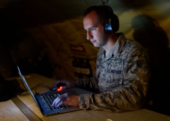 Senior Airman Ryan Zeski utilized time during a long flight as a passenger on a Michigan Air National Guard KC-135 Stratotanker to work on some homework for a course he was taking at Oakland University in in 2018. Photo by Tech. Sgt. Dan Heaton. 