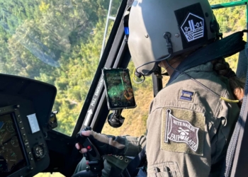 The Fort Rucker-based instructor pilot dons a "9/11 Never Forget" patch on her flight helmet. 