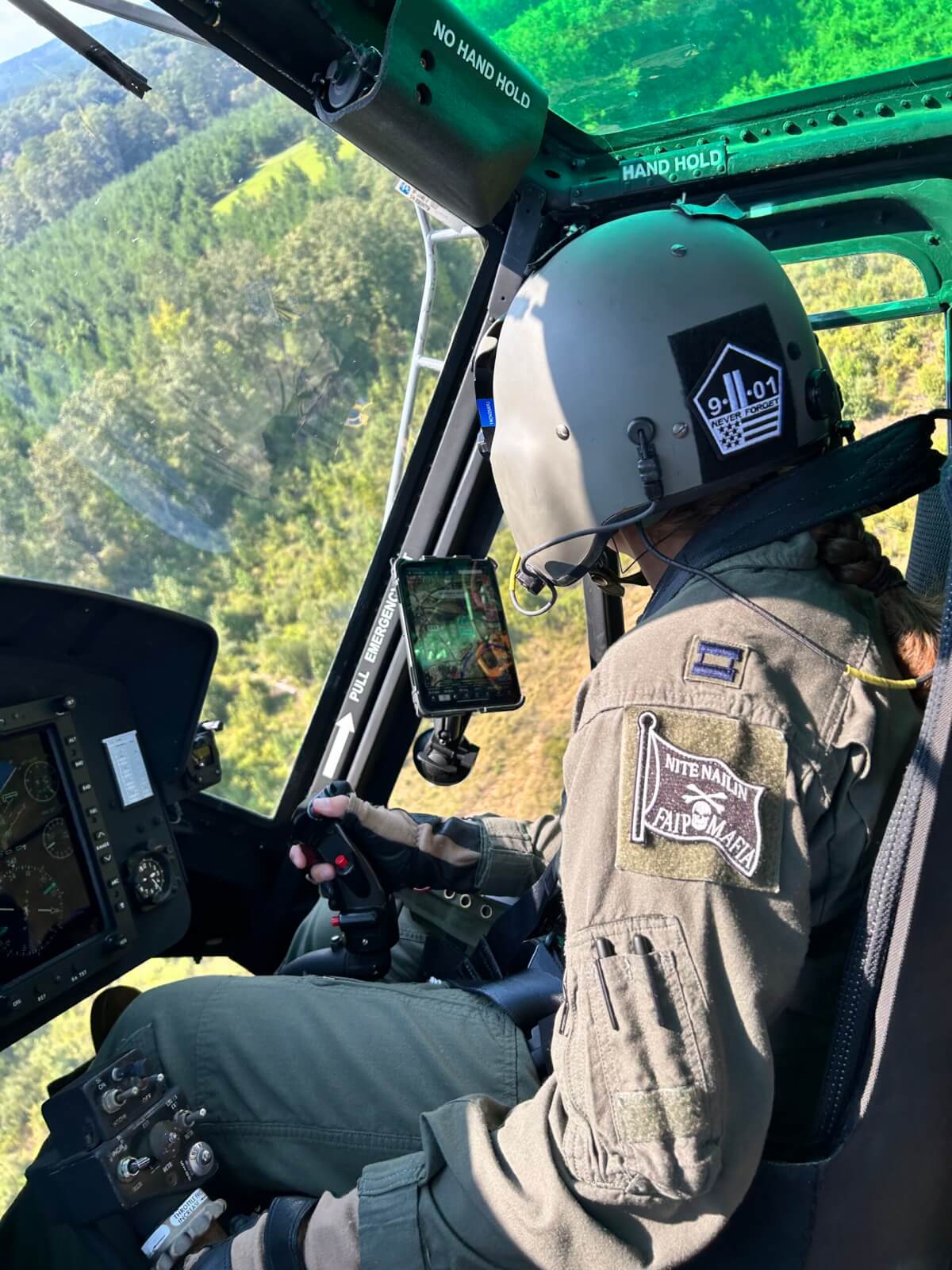 The Fort Rucker-based instructor pilot dons a "9/11 Never Forget" patch on her flight helmet. 